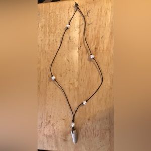 Necklace/stone or tooth with beads /not sure